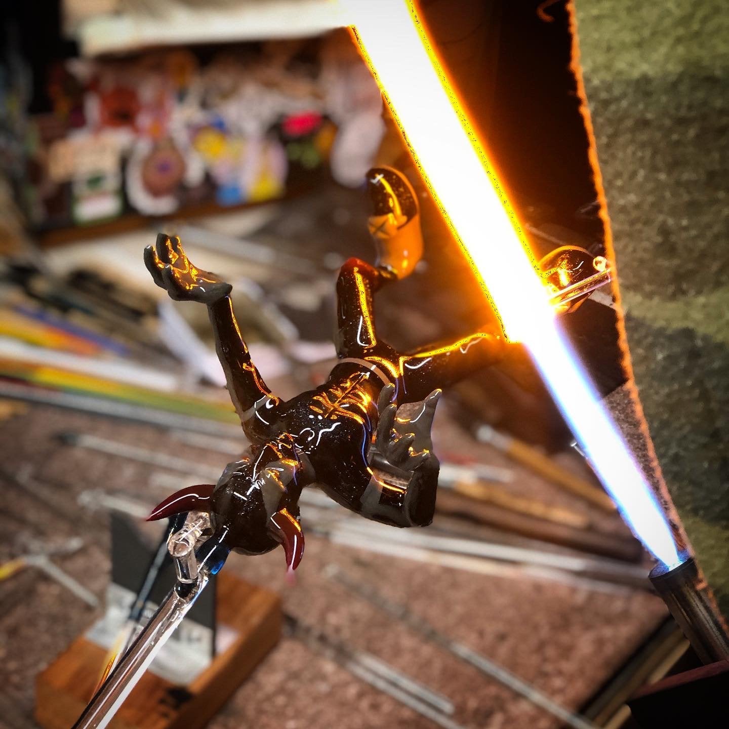 Close up photo of a glass piece being sculpted in the flame. 