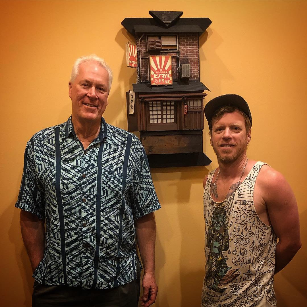 R3G15 is shown with a friend and mentor in front of his larger scale miniature project showcasing his friend's Sushi Restaurant. 