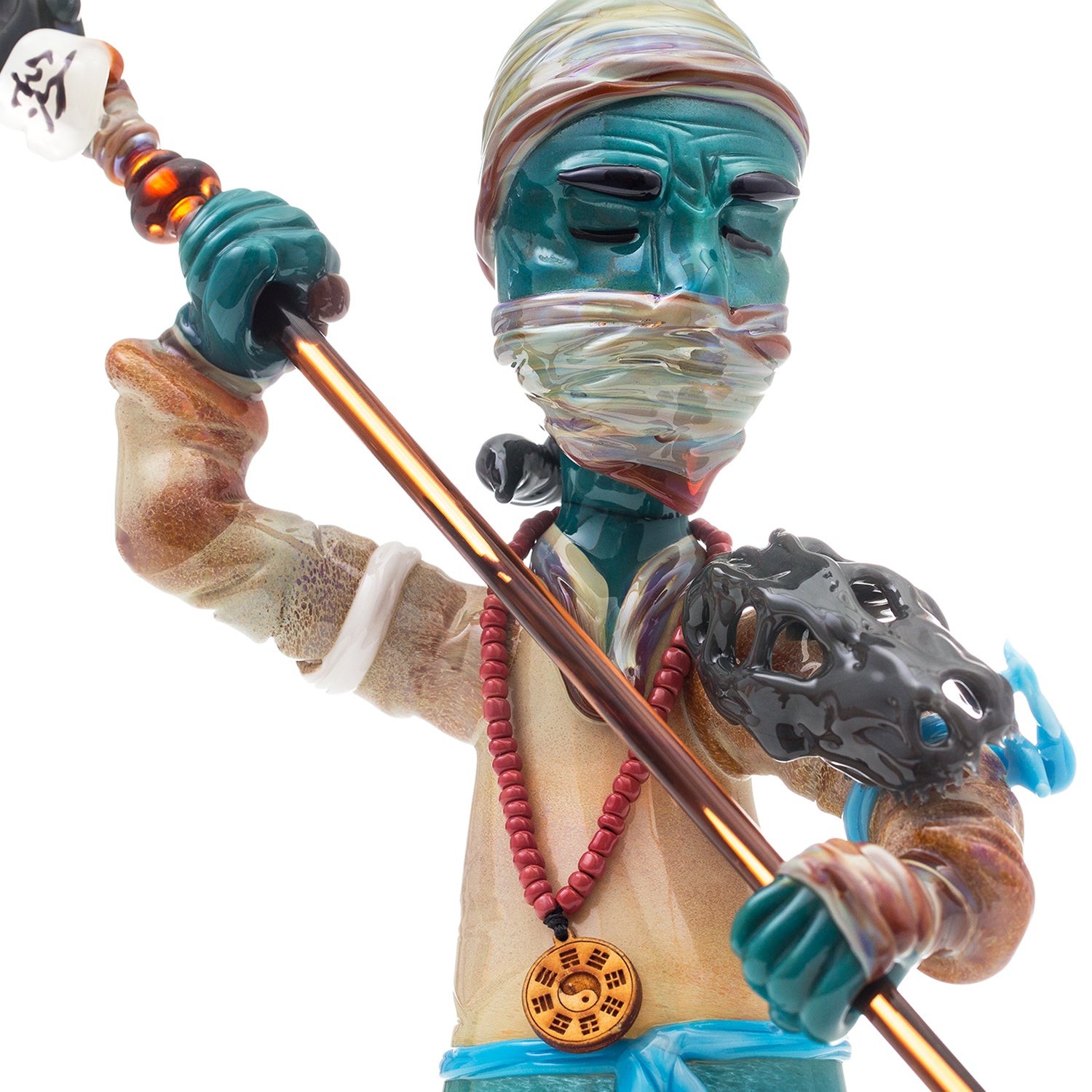 Studio Photo close up of a glass Ninja warrior with spear and skull armor on arm.